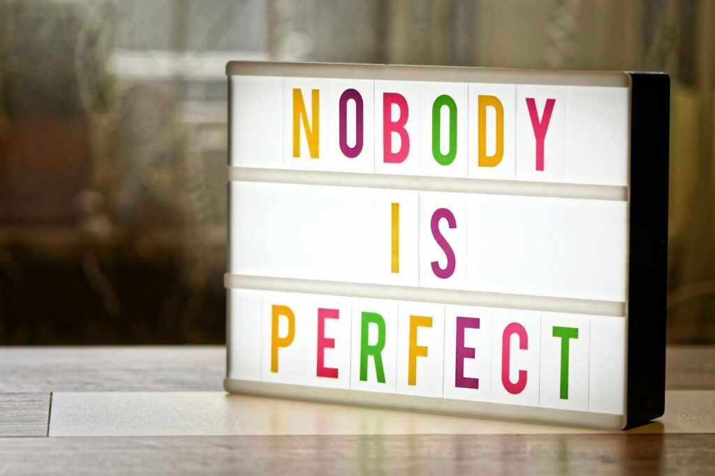 an illuminated text box saying nobody is perfect